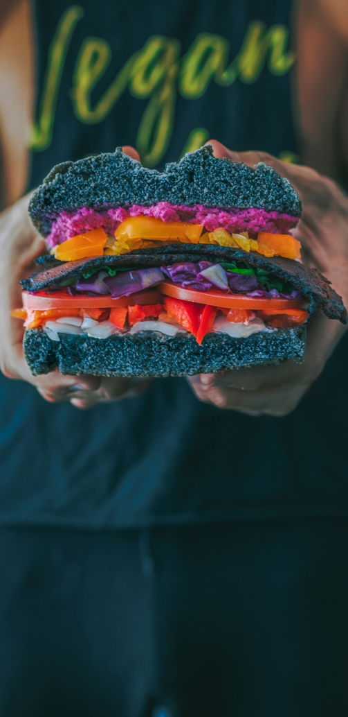 person-holding-meat-sandwich-with-sliced-tomatoes--onions--and-grilled-meat.jpg person holding meat sandwich with sliced tomatoes, onions, and grilled meat